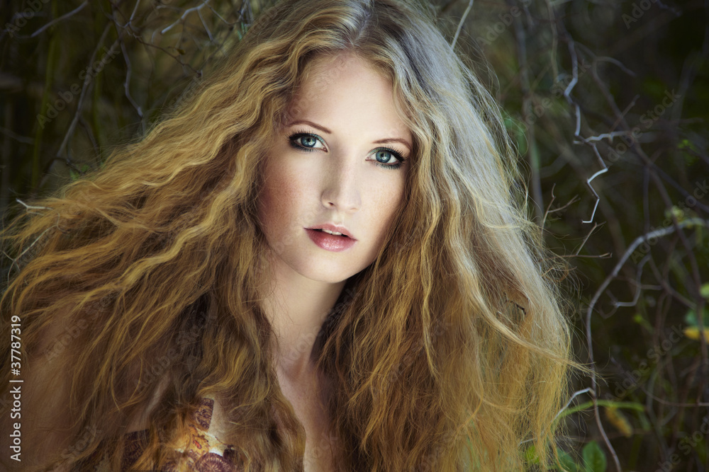 Naklejka premium Fashion portrait of young sensual woman in garden