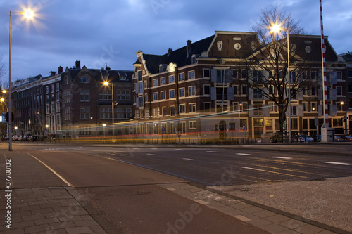 Busy Amsterdam Street at Sunrise