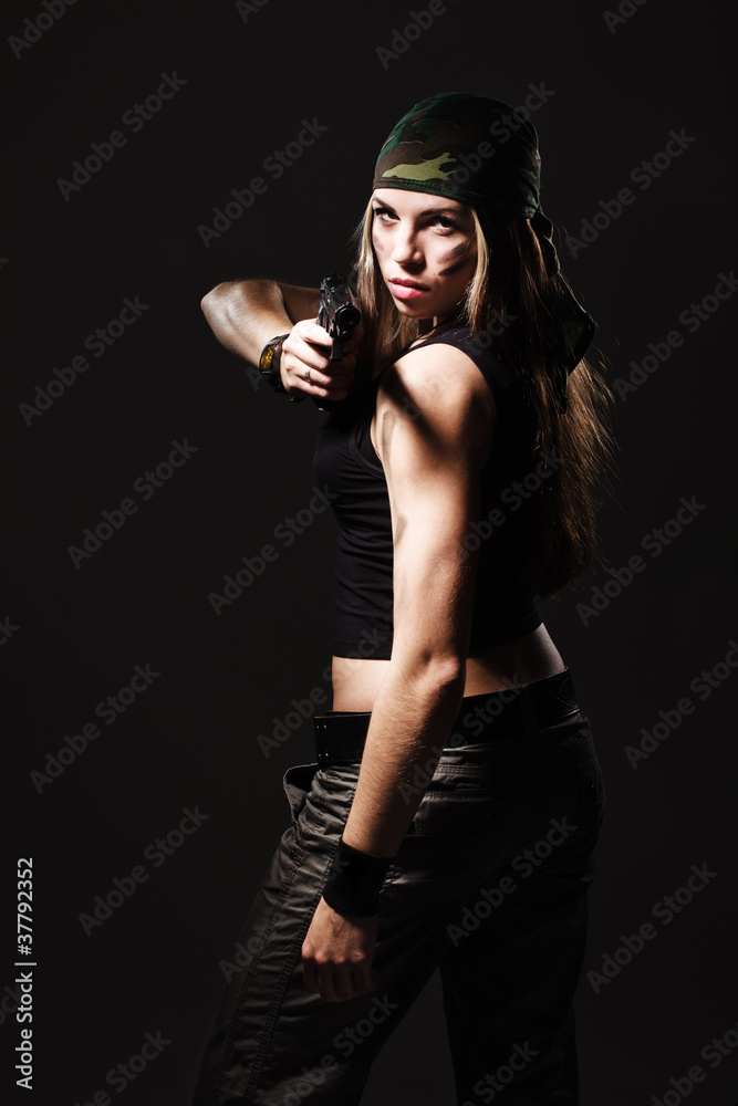 Fototapeta premium Sexy woman with Gun on dark