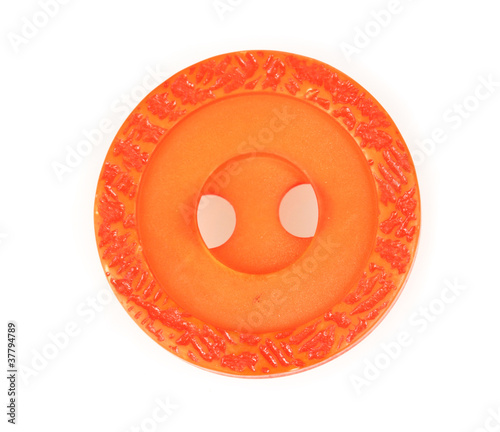 bright orange sewing button isolated on white.
