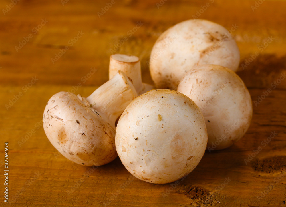 champignons mushrooms in basket on wooden table champignons mushrooms in basket on wooden table