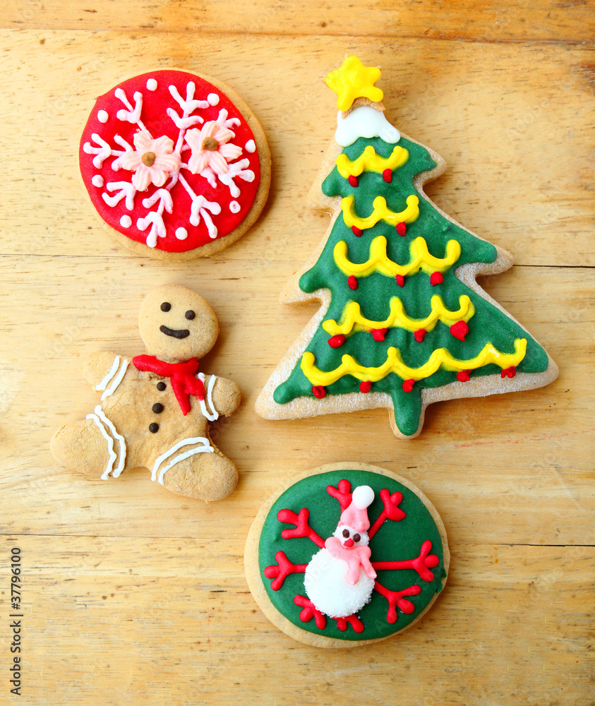 Decorated christmas gingerbreads on wooden background