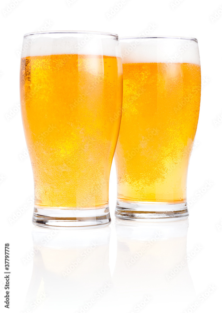 Two glasses fresh lager beer with foam Isolated on white backgro Two glasses fresh lager beer with foam Isolated on white backgro
