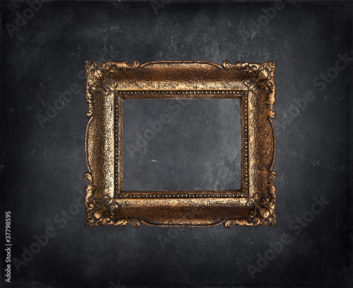Antique picture frame on black grunge wall