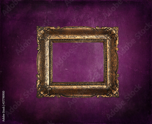 Antique picture frame on purple grunge wall