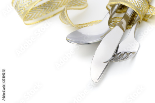 Spoon, fork and a knife tied up celebratory ribbon