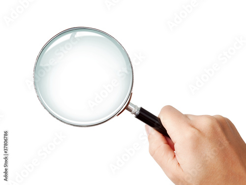 Man's hand holding classic styled magnifying glass