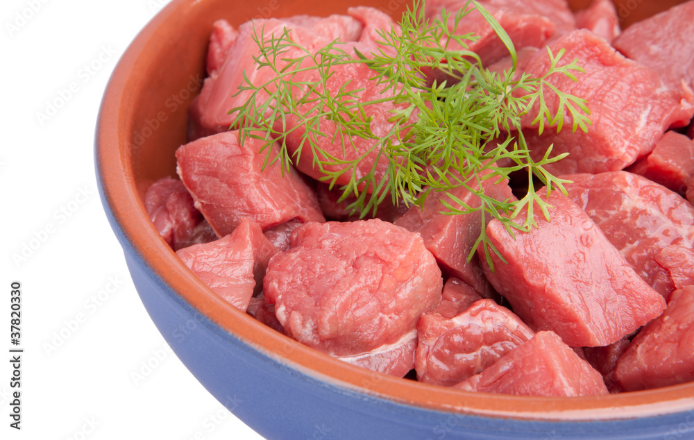 Raw sliced meat with dill  in a bowl