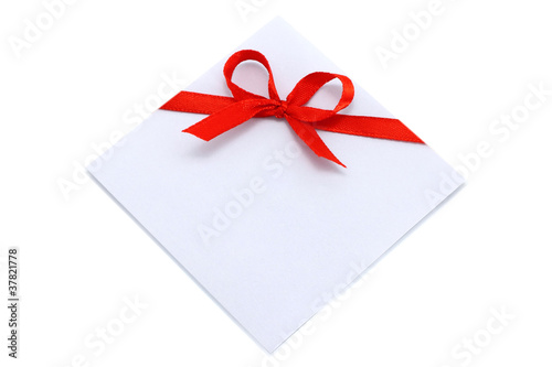Piece of paper with red bow on a white background