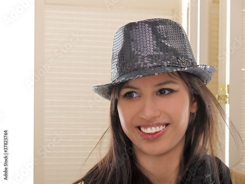 smiling girl wearing fedora hat
