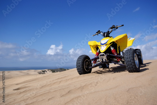 ATV Quad Racer on sand dune © kojihirano