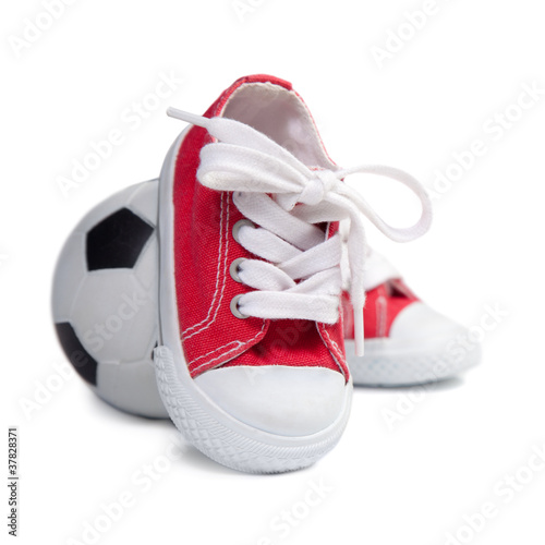Children's sneakers and soccer ball