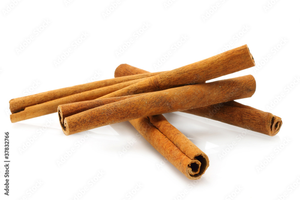 Heap of cinnamon sticks on white background