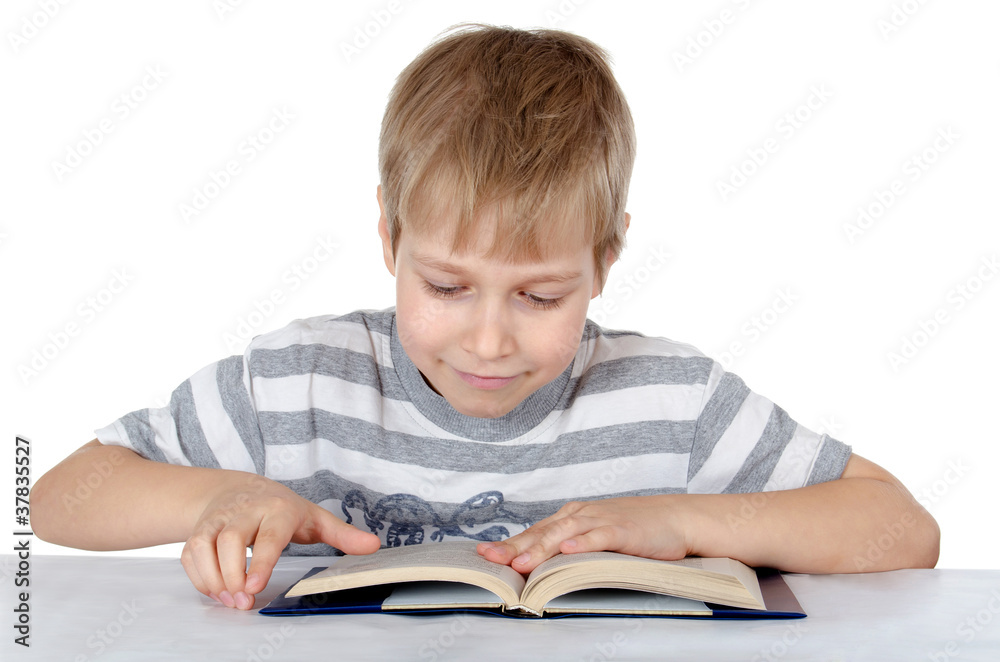 The boy reads the book isolated on white The boy reads the book isolated on white