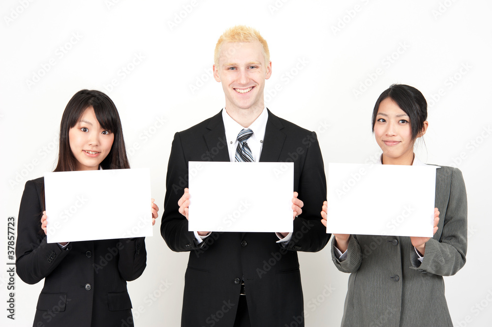 business team holding a blank whiteboard