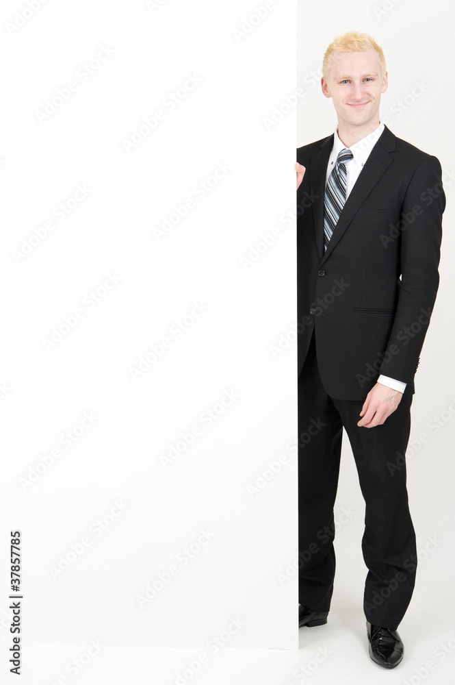 young businessman holding a blank whiteboard young businessman holding a blank whiteboard