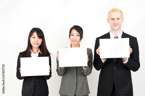 business team holding a blank whiteboard