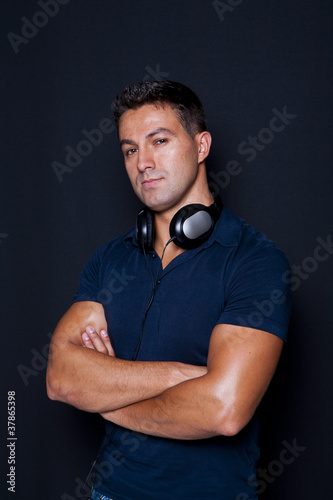 man standing with his arms crossed and headphones