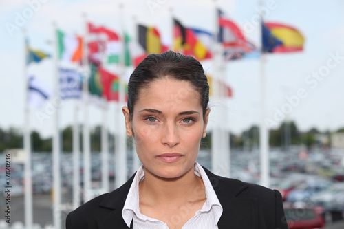 Brunette stood in front of flags