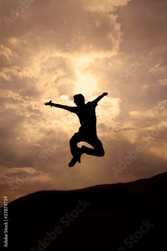 Wallpaper Mural Silhuette of young man jumping Torontodigital.ca