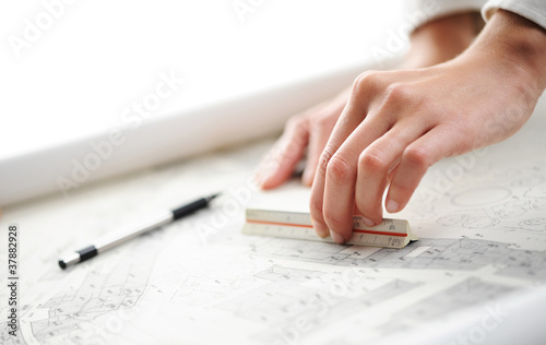 women hand on blueprint, shallow deep of field