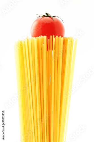 uncooked spaghetti noodles . Italian pasta with tomatoes