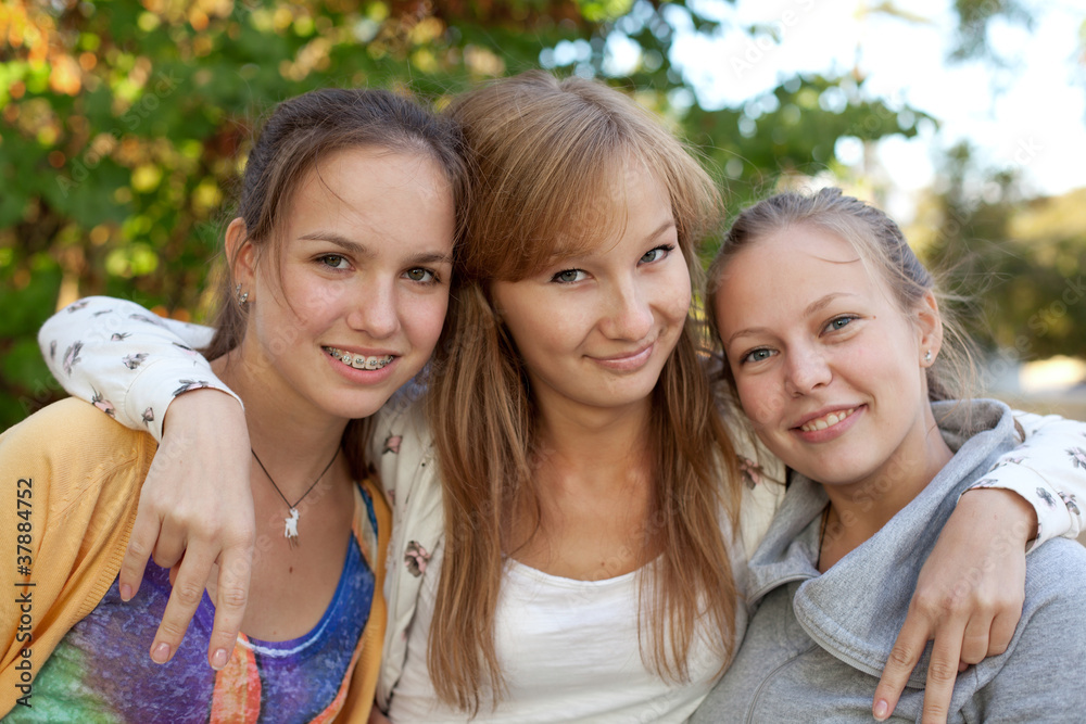 Portrait of three pretty student girls in the park Portrait of three pretty student girls in the park