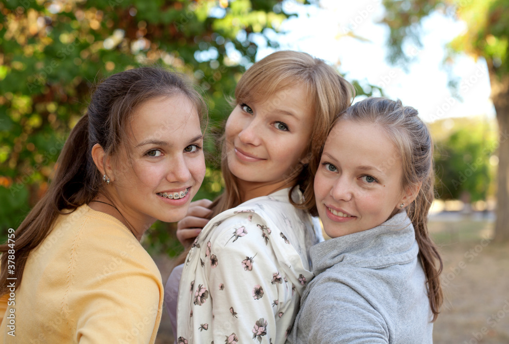Portrait of three pretty student girls in the park Portrait of three pretty student girls in the park