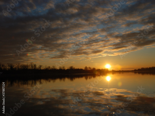 sunset with beautiful cloudy sky over lake