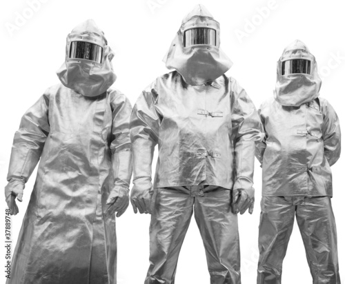 Foto Three workers in protective clothing designed to withstand extre