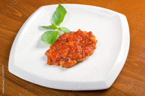 Grilled pork with tomato sauce.