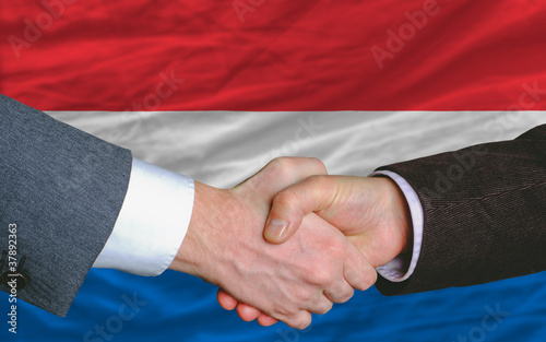 businessmen handshake after good deal in front of netherlands fl
