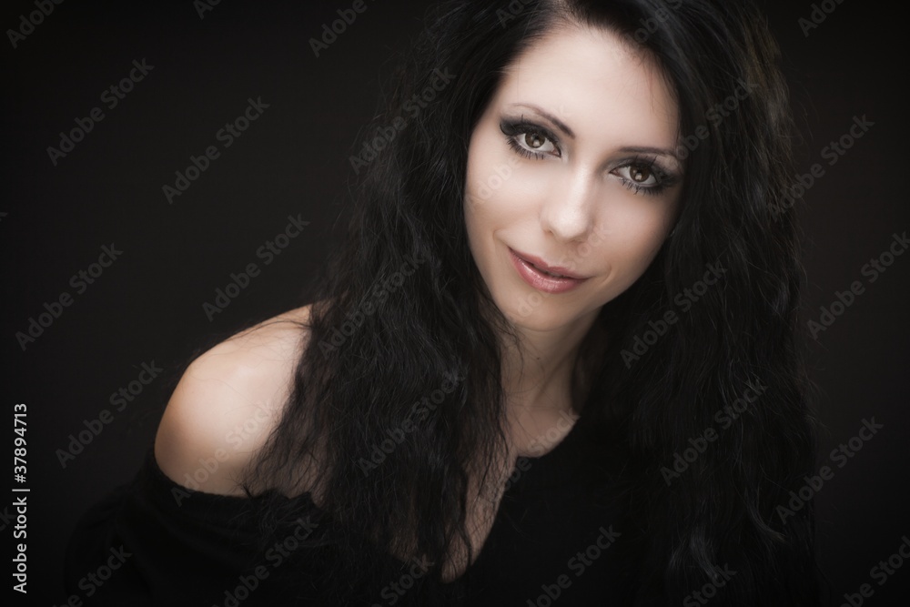 Young attractive gothic brunette woman over black Young attractive gothic brunette woman over black