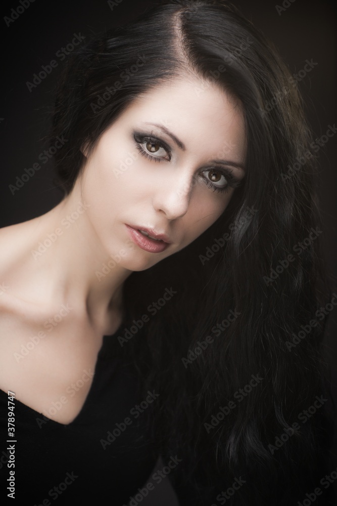 Young attractive gothic brunette woman over black Young attractive gothic brunette woman over black