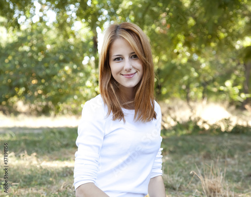 Portrait redhead girl at outdoor. Spring.