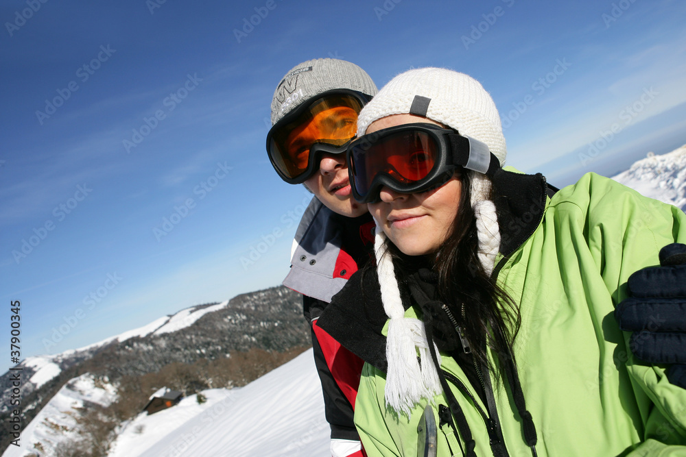a couple walking in snowy mountains