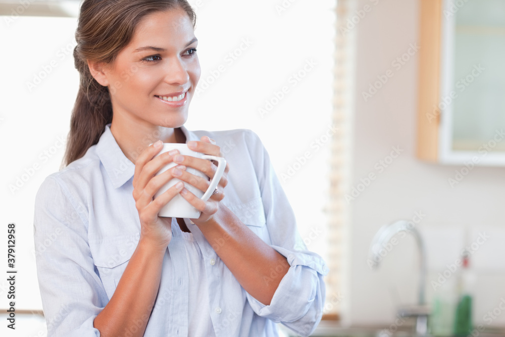 Smiling woman holding a cup of tea Smiling woman holding a cup of tea
