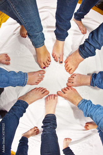 feet of girls with jeans in a circle