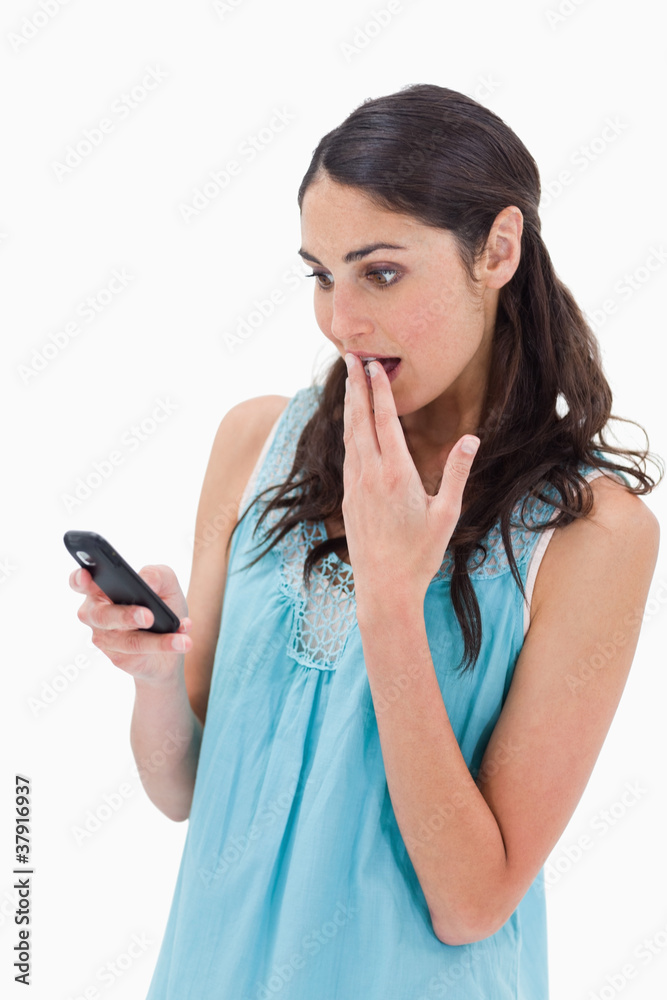 Portrait of a surprised woman reading a text message Portrait of a surprised woman reading a text message