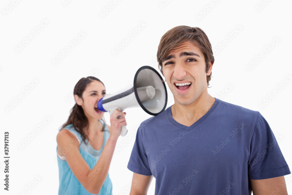 Woman yelling at her boyfriend through a megaphone Woman yelling at her boyfriend through a megaphone