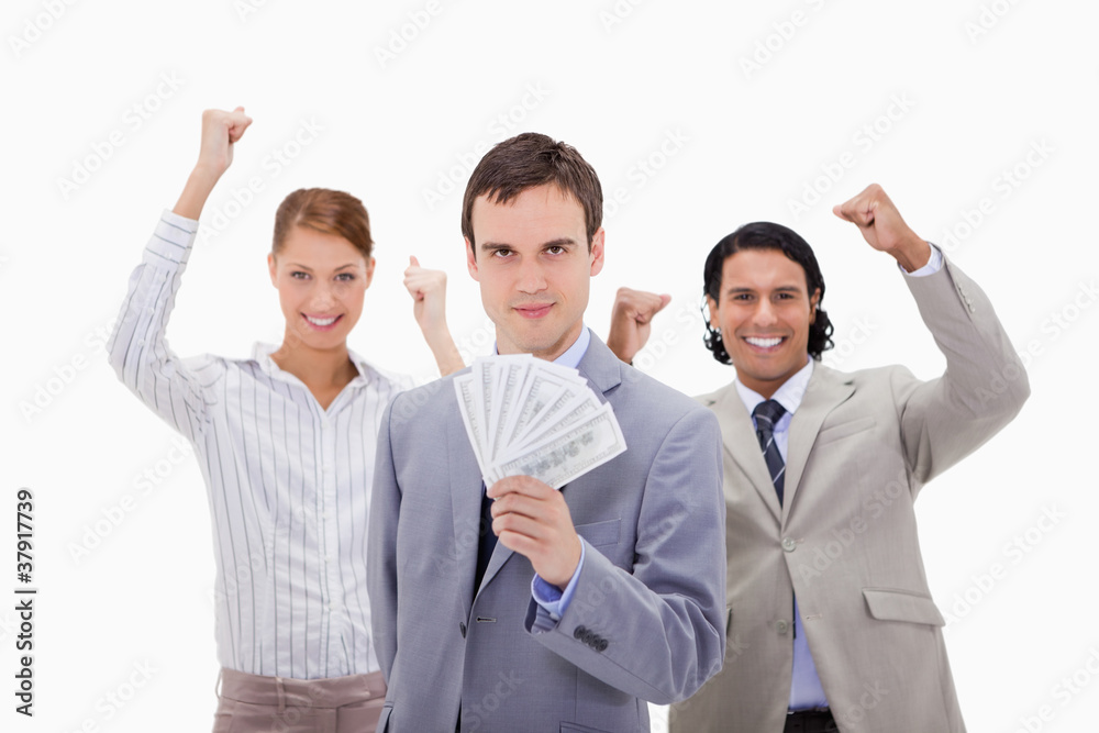 Businessman with cheering colleagues and money Businessman with cheering colleagues and money