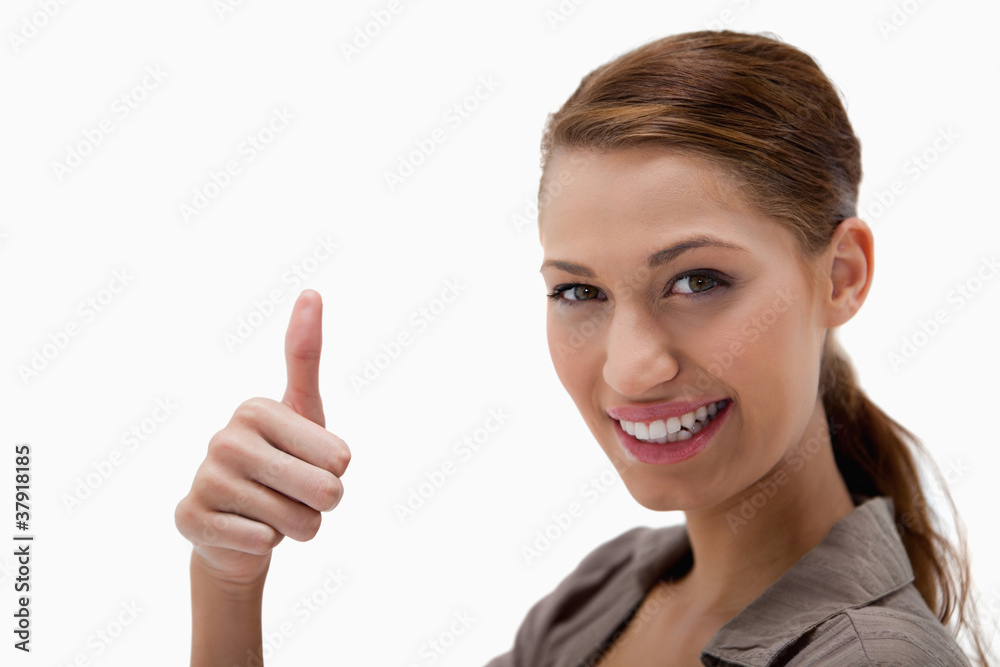 Side view of smiling woman giving thumb up Side view of smiling woman giving thumb up