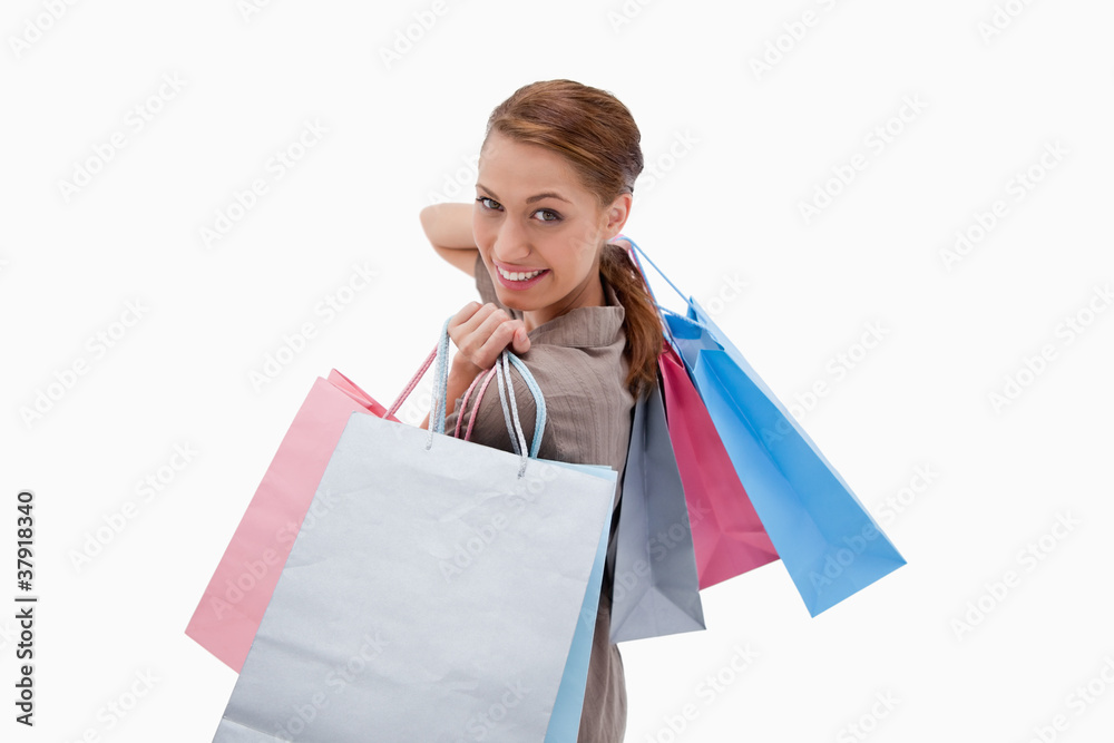Side view of smiling woman with shopping bags Side view of smiling woman with shopping bags