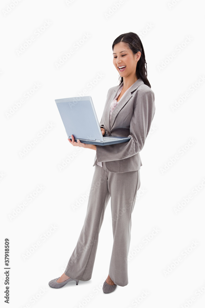 Side view of laughing businesswoman with laptop Side view of laughing businesswoman with laptop