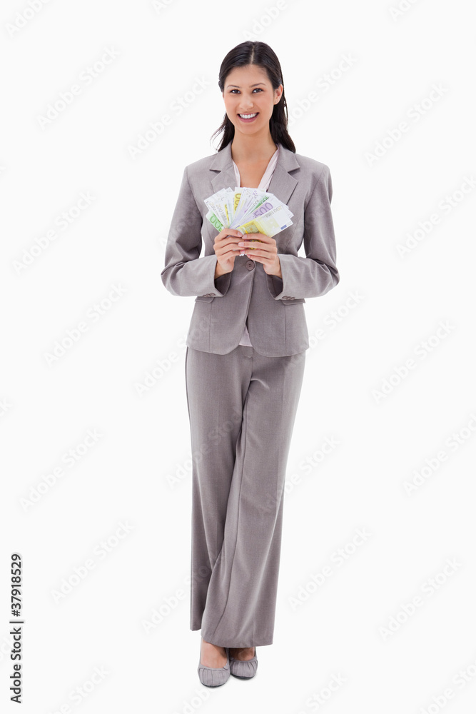 Smiling businesswoman holding money Smiling businesswoman holding money