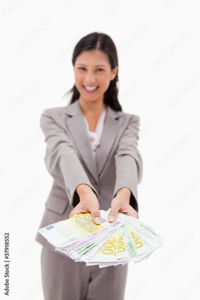 Money being offered by smiling businesswoman Money being offered by smiling businesswoman
