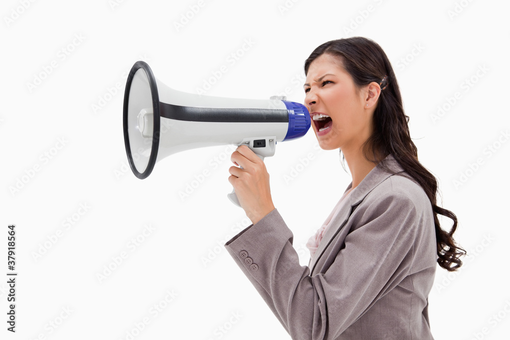 Side view of angry businesswoman shouting through megaphone Side view of angry businesswoman shouting through megaphone