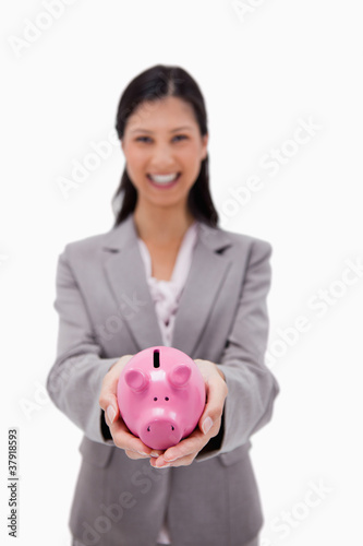 Piggy bank being held by businesswoman