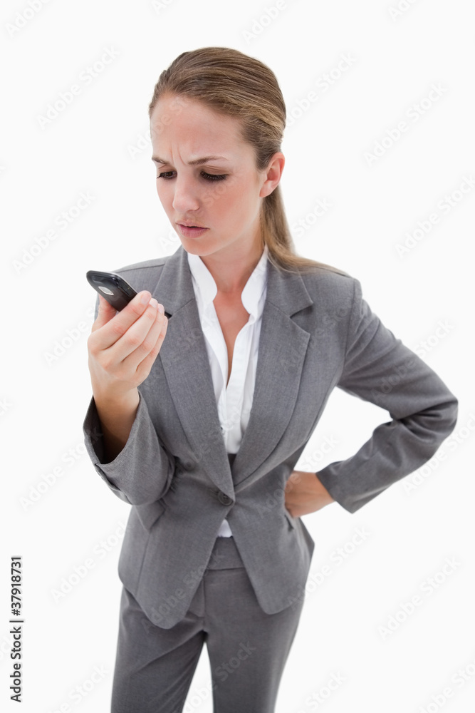 Irritated bank employee reading text message Irritated bank employee reading text message