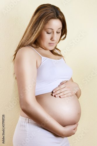 Portrait of beautiful pregnant woman touching her belly Free Download Portrait of beautiful pregnant woman touching her belly - GFXLoad